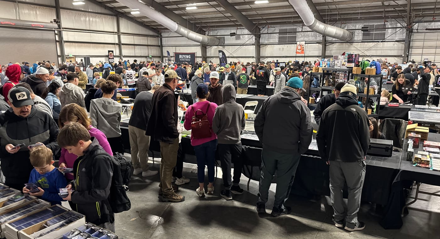 Hundreds of collectors filling the show floor at Norris Penrose — vendor tables and a Buying, Selling and Trading banner in the background